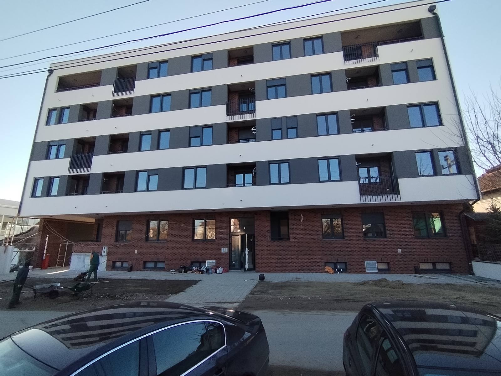 Jerneja Kopitara residential development in Novi Sad, Serbia with brick base, rendered bands and street-front balconies