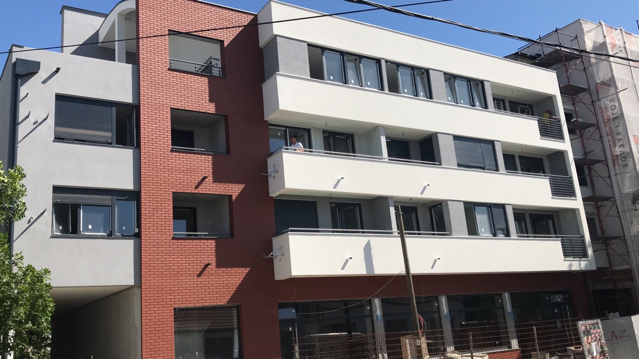 Completed residential and mixed-use building in Serbia with brick and rendered façade and recessed balconies