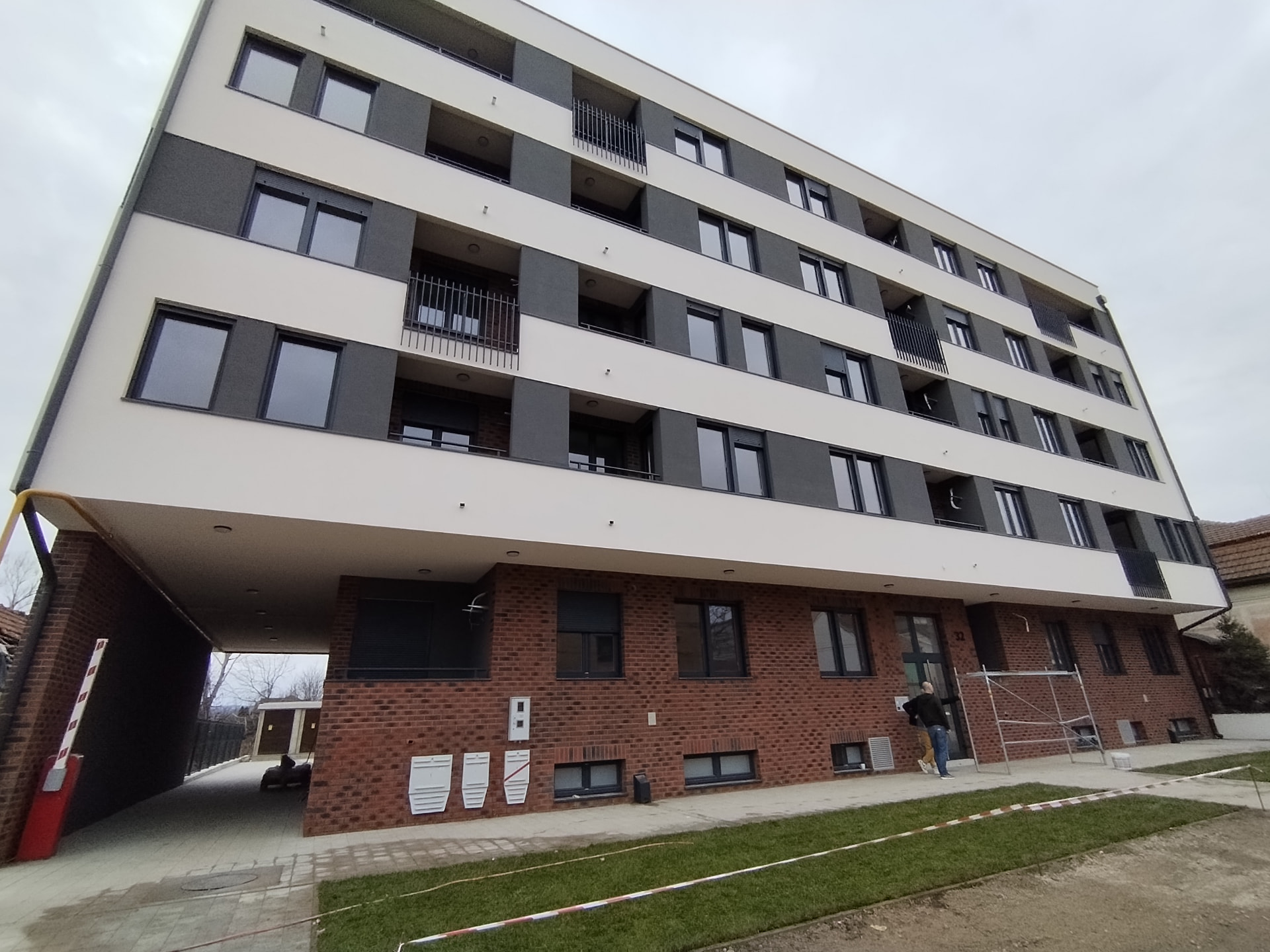 Completed residential and mixed-use development in Serbia with covered passage and landscaped frontage